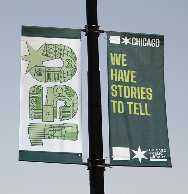 Chicago Public Library 150th anniversary promotional banners hanging from a street light in Lincoln Park, Chicago.