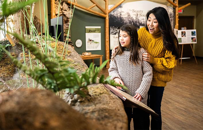 A mom an daughter exploring an exhibit at the Ridges.