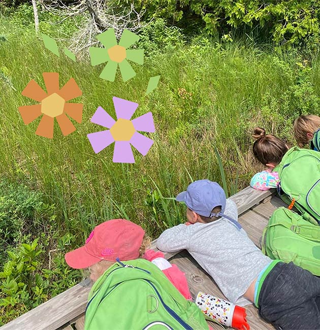 Kid visitors at the Ridges exploring the grass from the boardwalk.