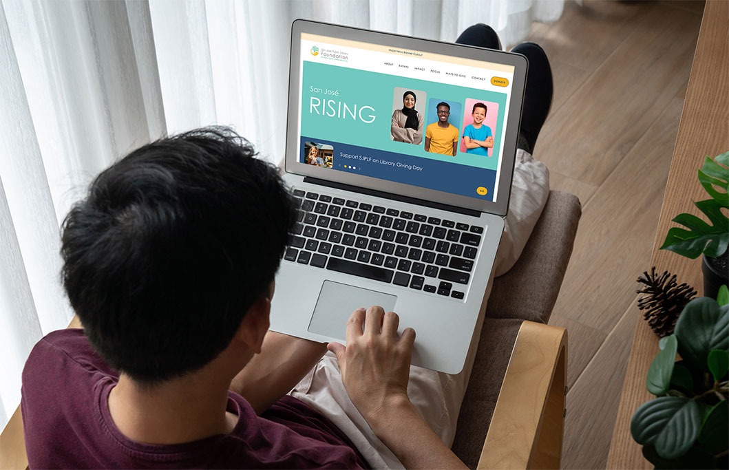 A visitor to SJPLF's website homepage on a laptop.