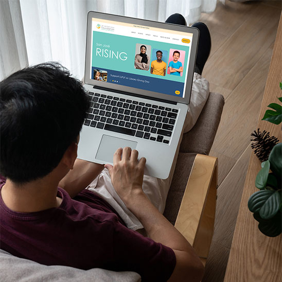 A visitor to SJPLF's website homepage on a laptop.