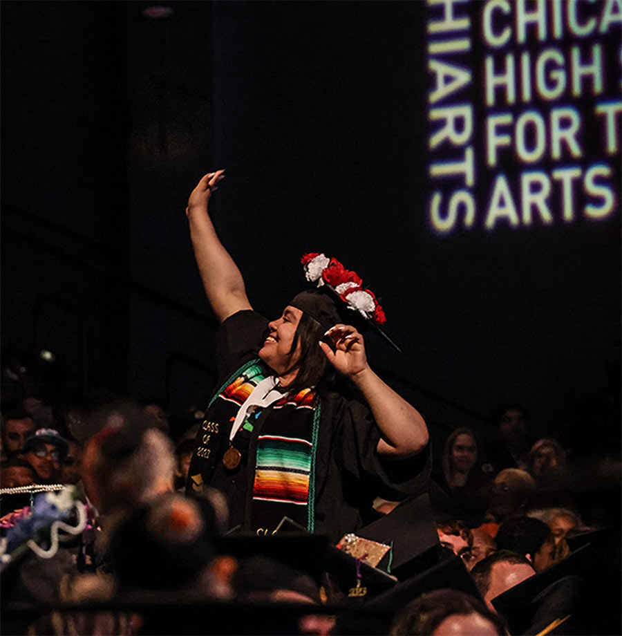 A ChiArts student strikes a pose during graduation.