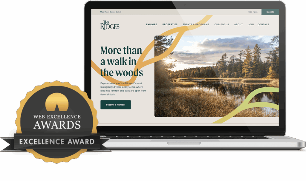 The Ridges website on a laptop next to a badge for the Web Excellence Awards.